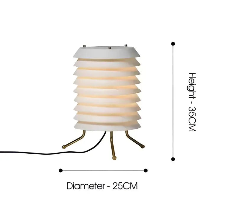 A sleek white tiered decorbites geometric iron table lamp with a warm glow and brass-colored metal legs for living room light