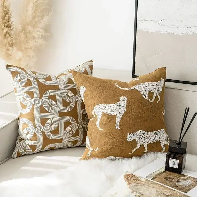 Tan cushion cover with white embroidered cheetah silhouettes on textured fabric decorbites geometric jacquard design