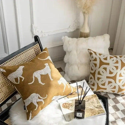 Tan cushion cover with white cheetah silhouettes in a decorbites geometric jacquard pattern for living room decor