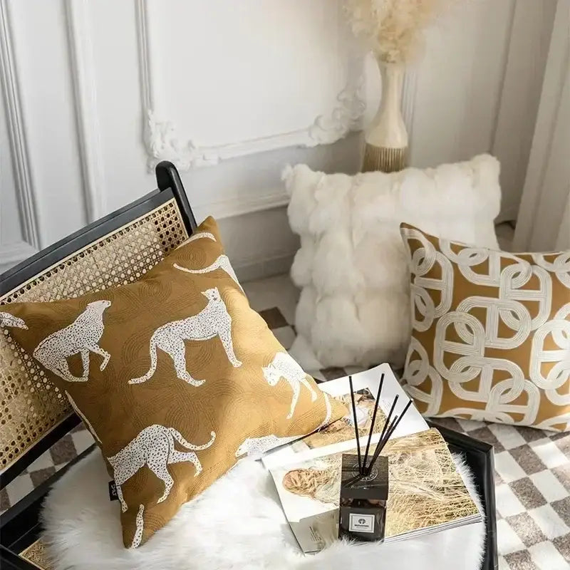 Tan cushion cover with white cheetah silhouettes in a decorbites geometric jacquard pattern for living room decor