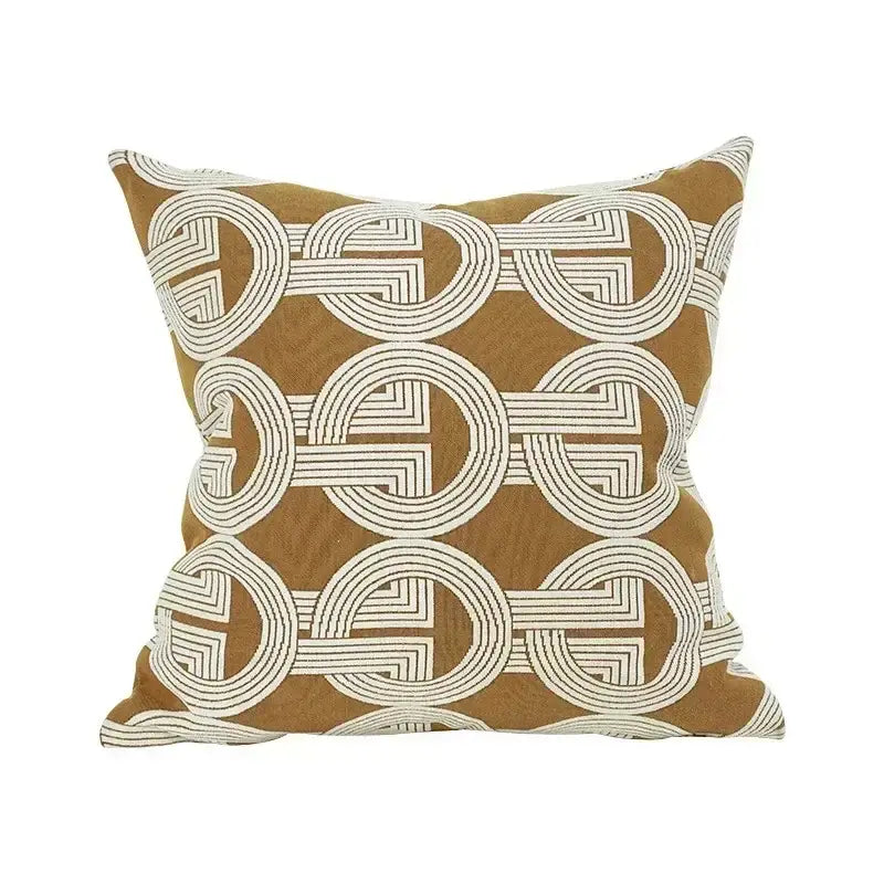 A mustard cushion cover with white embroidered interlocking circles featuring decorbites geometric jacquard design