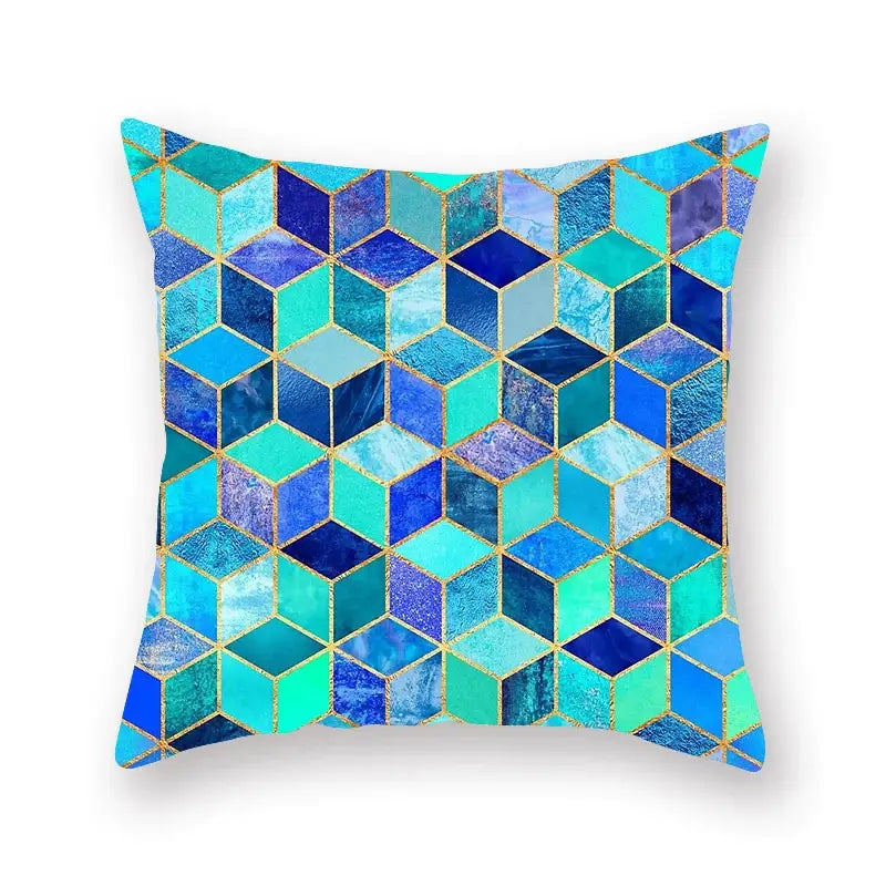 A modern square throw pillow with a decorbites geometric leaf pattern in teal blue and gold foil accents for living room decor