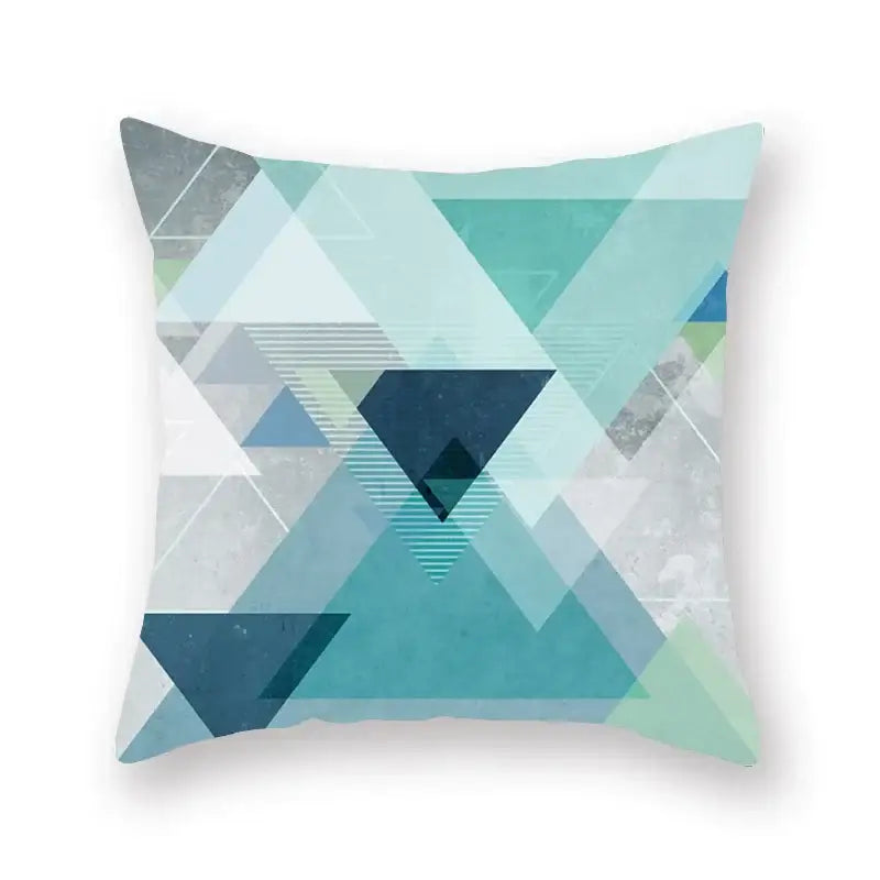 A square throw pillow with a decorbites geometric leaf design in teal blue and gray for modern living room decor