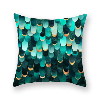 A square throw pillow with vibrant teal and black geometric leaf flower pattern and gold-trimmed edges for decorbites geometric leaf decor