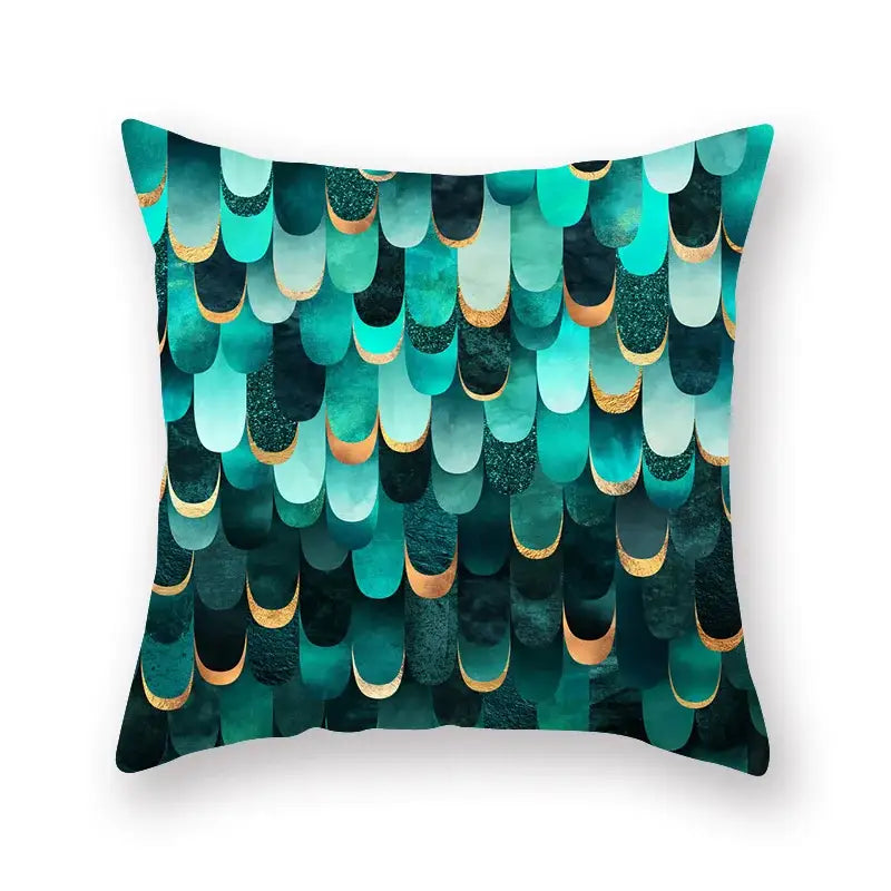 A square throw pillow with vibrant teal and black geometric leaf flower pattern and gold-trimmed edges for decorbites geometric leaf decor