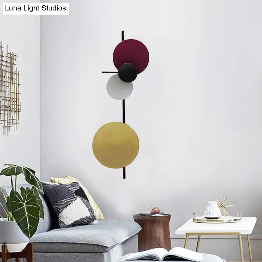 Modern geometric led wall light with burgundy black and gold discs on black rod in red pink blue for living room sconce