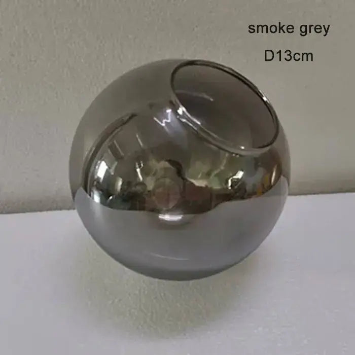 Smoke grey spherical glass vase with single top opening featured in modern geometric magic bean lighting design