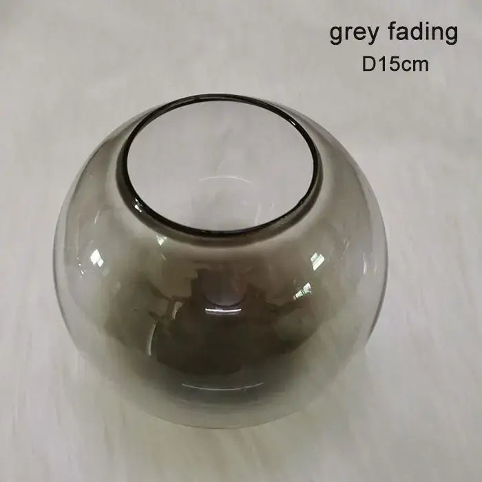 A translucent grey glass vase with a smooth rounded body and darker rim for modern geometric magic bean lighting