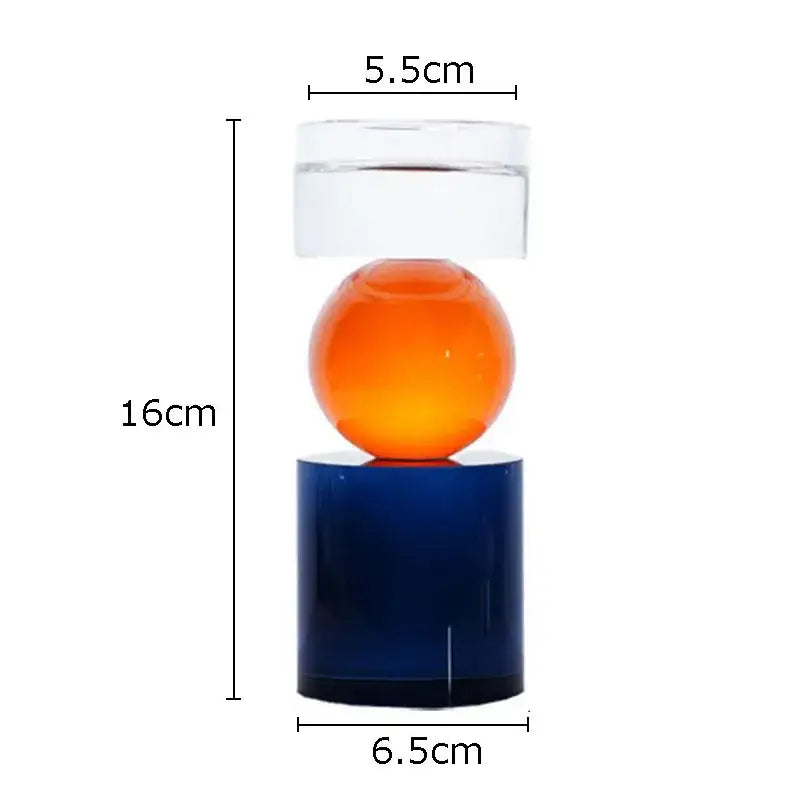 Modern geometric crystal candle holders with a vibrant orange sphere and deep blue base for dining room decor