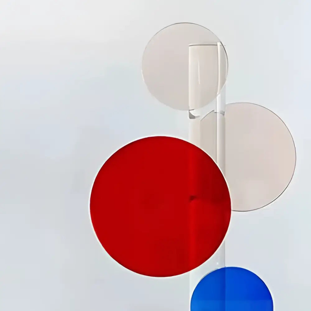 A vibrant red acrylic geometric ring among blue and transparent discs in modern decorbites crystal home decor sculpture