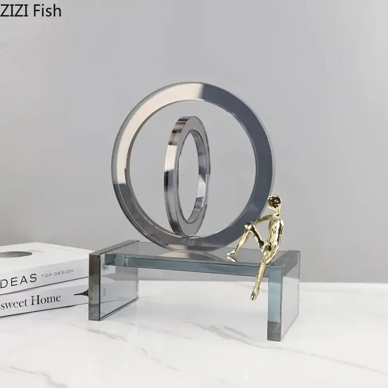 Shiny chrome and gold abstract geometric ring chair statue with interlocking rings and miniature figure on ring chair base