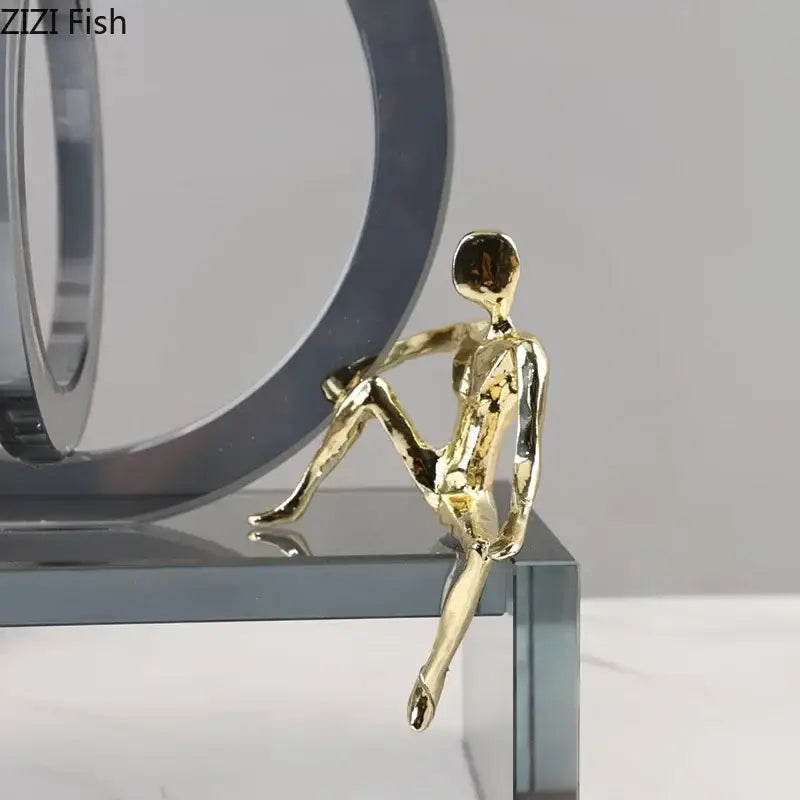 Golden metallic figurine with smooth abstract contours showcased alongside modern geometric ring chair base decor