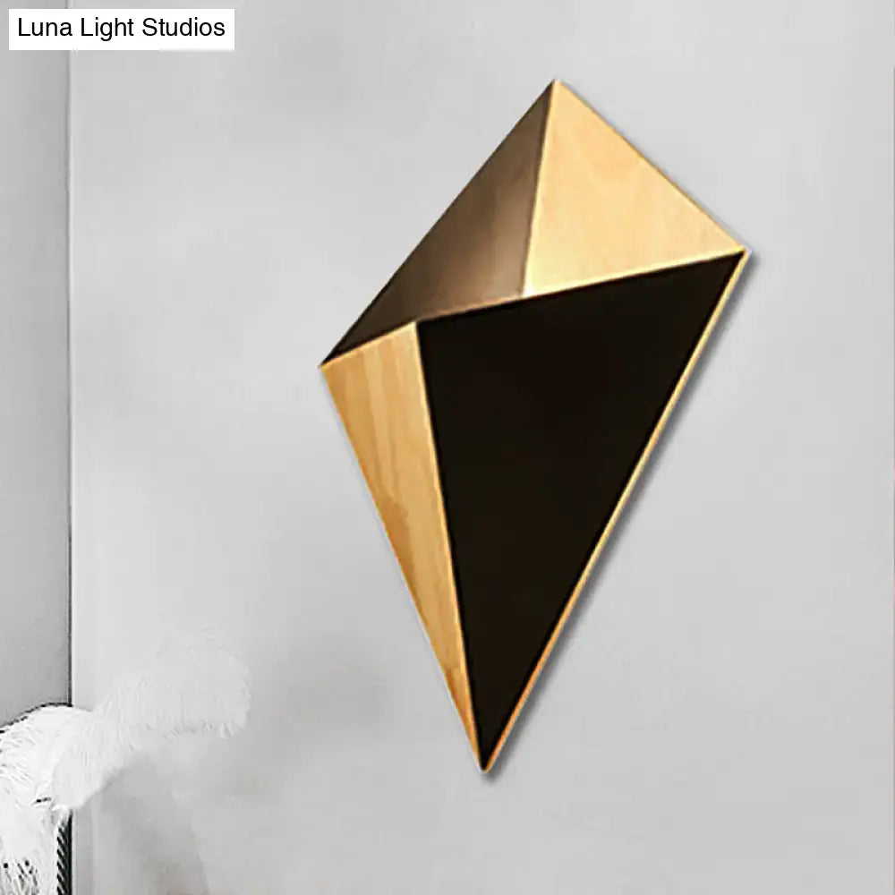 Modern geometric rubber wood wall sconce with faceted gold-toned wood and matte black panels for bedroom use