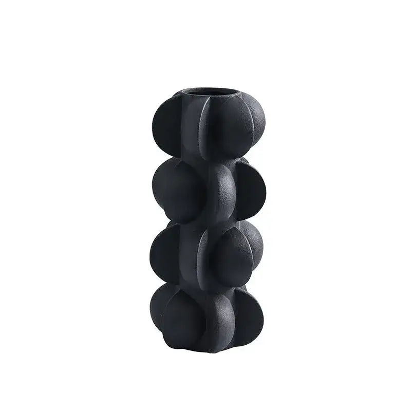 Black ceramic vase with textured segmented design resembling stacked spheres for modern geometric spiral decorbites geometric spiral resin decor