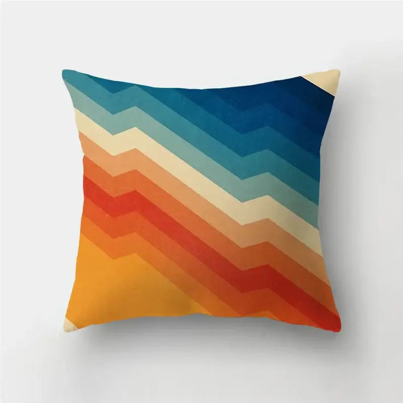 Modern geometric stripe patchwork pillow case with vibrant retro chevron pattern in blue, teal, cream, orange, and red hues