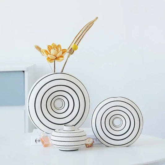 White ceramic vase with black geometric stripes featuring a minimalist modern design for living room decorbites decor