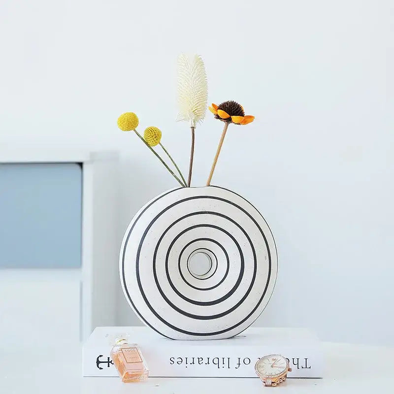 White ceramic vase with geometric stripes featuring concentric black circular bands for living room decorbites decor