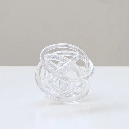 Clear glass modern geometric coil wound ball sculpture with interlocking rings for living room decor