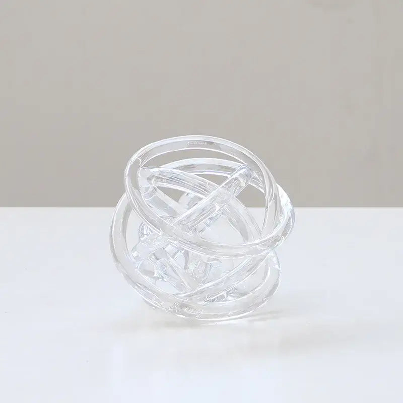 Clear glass modern geometric coil wound ball sculpture with interlocking rings for living room decor