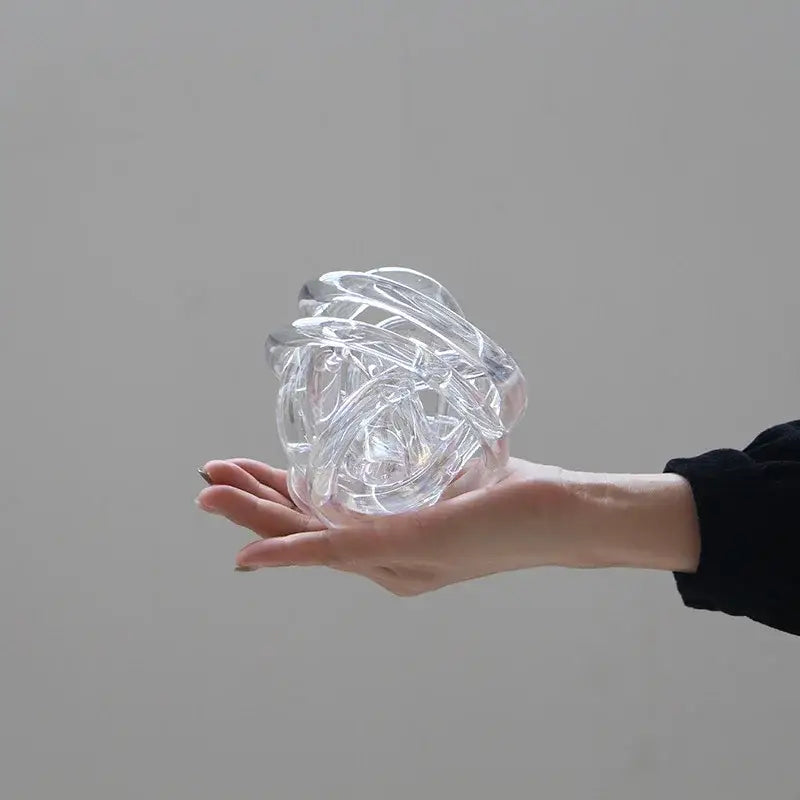 Modern geometric transparent glass coil wound ball with intricately twisted design for living room decor