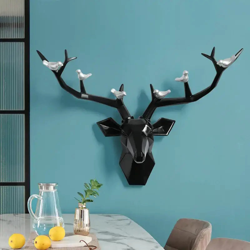 Black geometric decorbites deer head wall with silver birds perched on antlers for modern living room decor