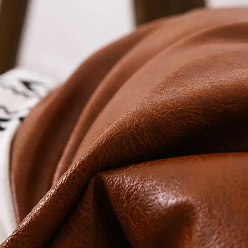 Modern geometric white and black cushion cover with rich brown decorbites brown faux leather textured surface and tassels