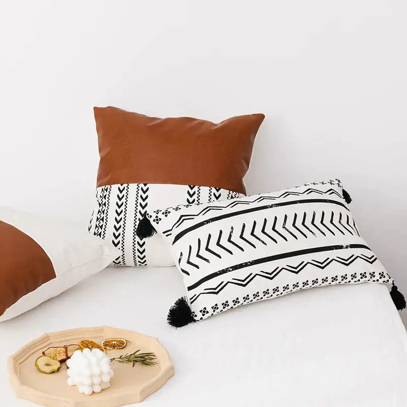 Modern geometric white and black cushion cover with tassels featuring faux leather accents for decorbites brown faux style