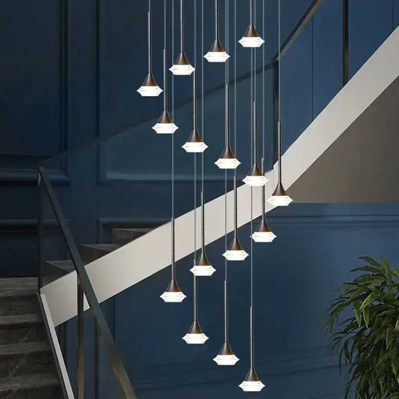 Modern brass-toned pendant lights with faceted white glass shades in a cascading decorbites deluxe villa chandelier design