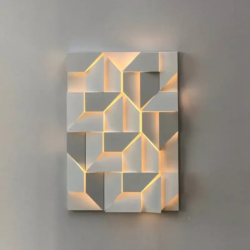 Modern geometric white grand sconce lamp with gray panels illuminated by warm yellow led lighting for bedroom decorbites grand sconce