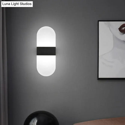 Modern geometric wood and acrylic wall sconce lamp with a sleek pill-shaped frosted glass wall sconce lamp