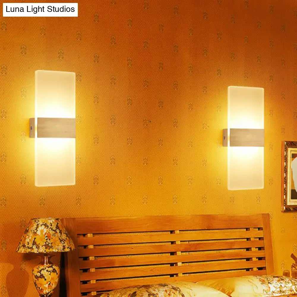 Modern geometric wood and acrylic wall sconce lamp with frosted glass panels and metallic accents for bedroom lighting