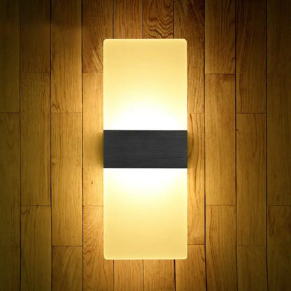 Modern geometric wood and acrylic wall sconce lamp with warm glow and black accent strip for bedroom wall lighting