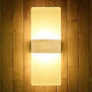 Modern geometric wood and acrylic wall sconce lamp with warm glowing diffuser and horizontal wooden accent wall lamp