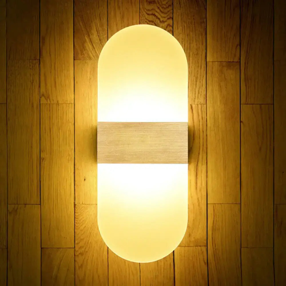 Modern geometric warm-toned wall sconce lamp with frosted glass diffuser and central wooden accent for bedroom lighting