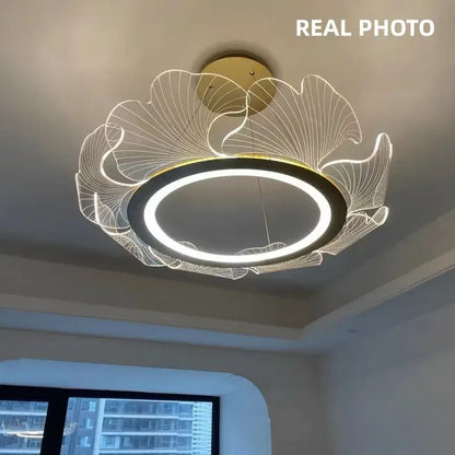 Modern ginkgo gold acrylic pendant light with gold-toned circular led ring and illuminated leaf wireframe design for dining room