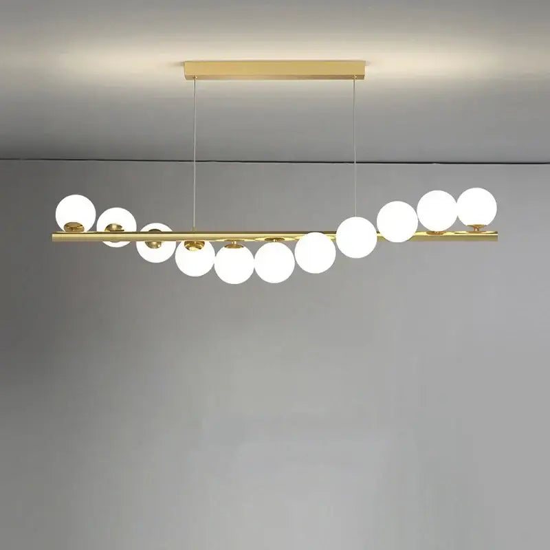 Modern glass ball gold chandelier featuring a sleek horizontal bar with white spherical glass globes for dining room decorbites glass ball pendant light