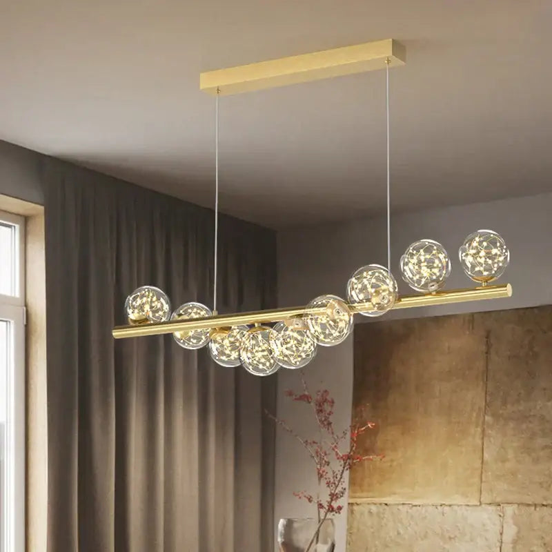 Modern glass ball gold chandelier featuring a gold-toned horizontal bar with clear glass spheres led dining pendant light decorbites glass ball