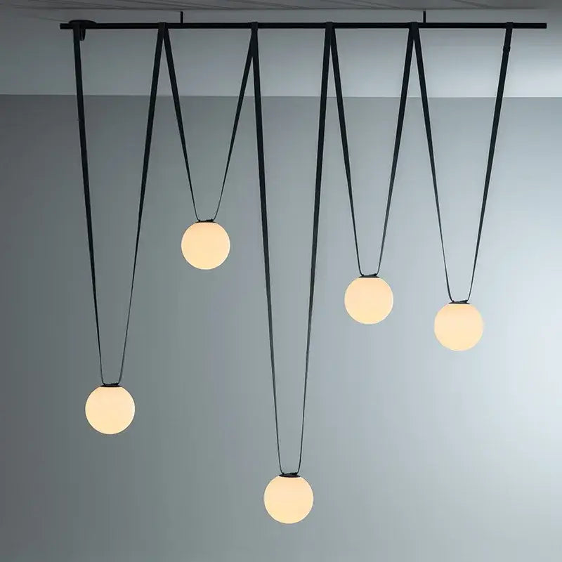 Modern black metal pendant light with five frosted glass ball led globes by decorbites for living room decor