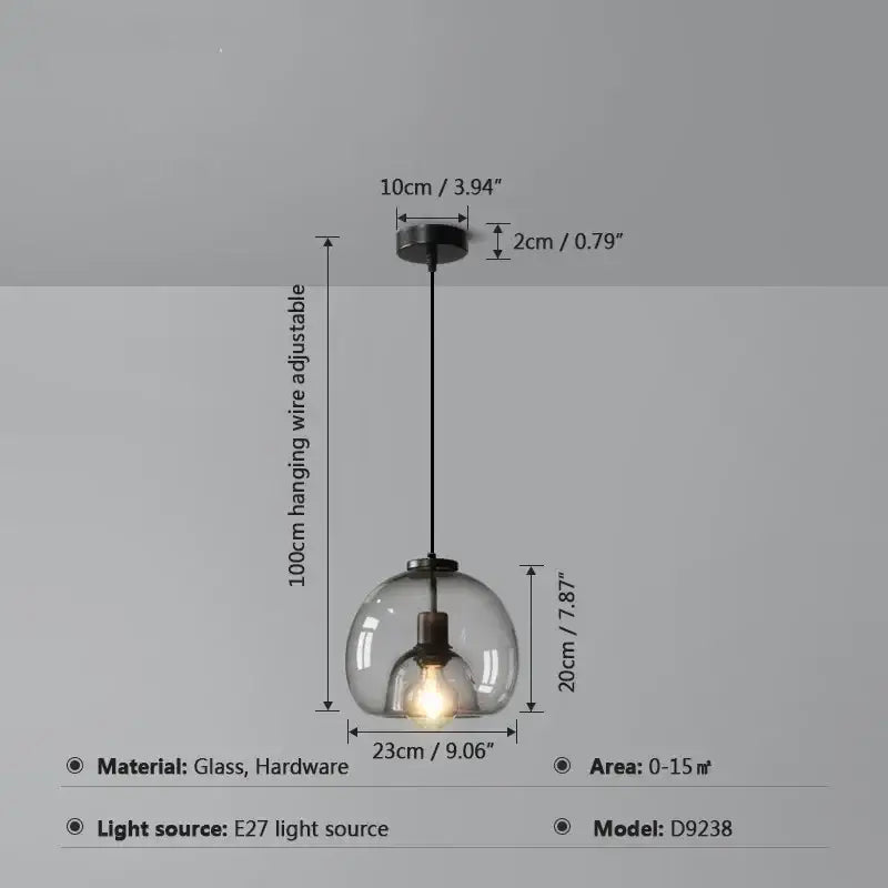Modern glass ball led pendant lights with a clear glass globe, black hanging wire, and metal hardware for dining room decorbites