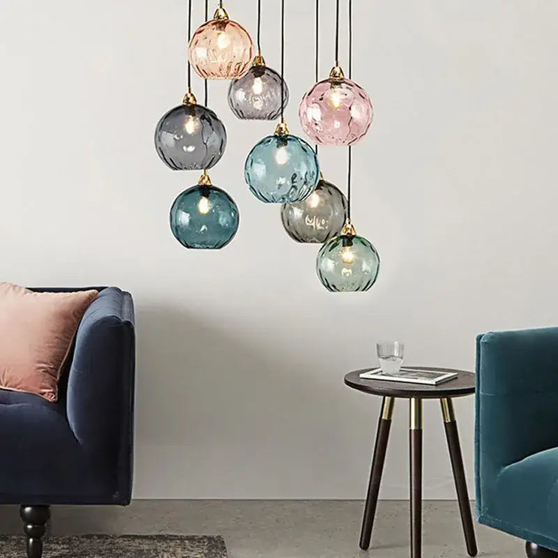 A modern pendant light with pink blue and gray textured glass ball lustre globes for kitchen decorbites lighting