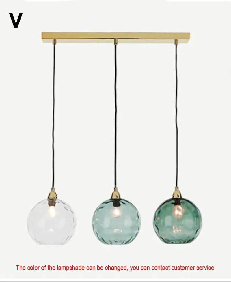 Modern three-light pendant lights with brass bar and teal decorbites glass ball lustre shades for kitchen cluster