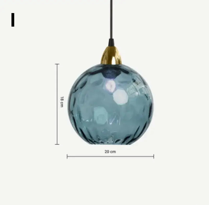 Modern glass ball lustre pendant lights featuring a blue textured glass ball and gold-toned metal fixture by decorbites