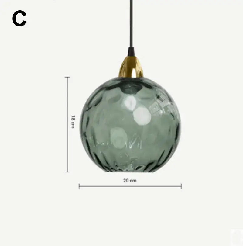 A sleek sage green textured glass ball lustre pendant light with polished brass fixture and black cord for decorbites kitchen cluster pendant lights