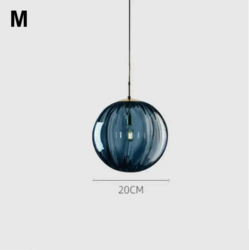 Modern glass ball lustre pendant lights featuring a 20cm deep blue ribbed glass ball and brass suspension for kitchen decorbites