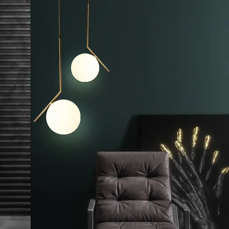 Modern gold-toned glass ball pendant light with frosted shades and metal arms for dining room decorbites pendant light