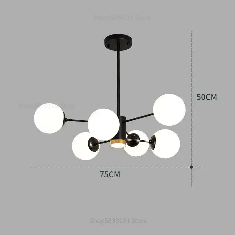 Modern black metal chandelier with six frosted glass ball pendant lights and central brass accent for living room decorbites glass ball
