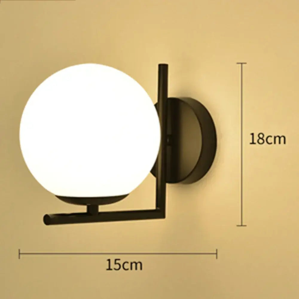 Black metal wall lamp with a frosted white glass ball globe perfect for modern bedroom decorbites glass ball sconce