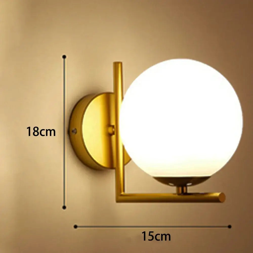Gold-finished modern glass ball wall lamp with a frosted white spherical glass shade for bedroom decorbites glass ball sconce