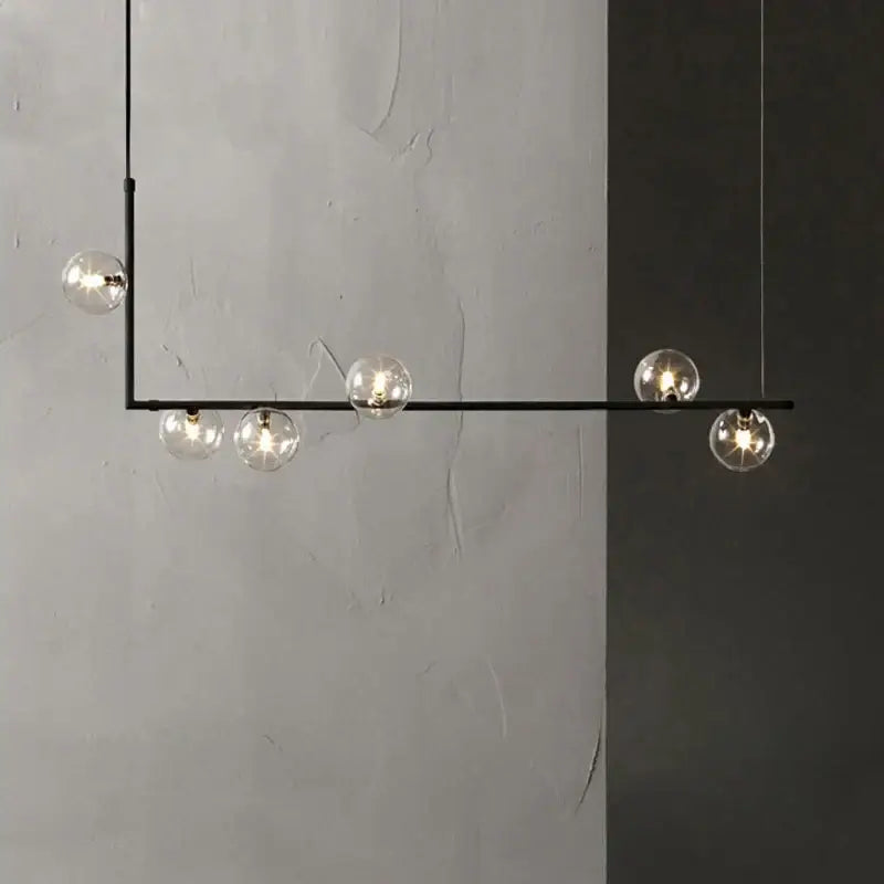 Modern glass black chandelier featuring five clear glass globe bulbs and gold accents for dining room decorbites glass black
