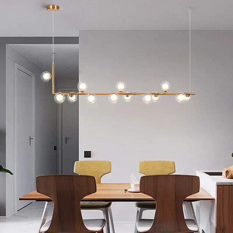 Modern glass black chandelier gold pendant light with multiple spherical glass bulbs on a sleek horizontal bar